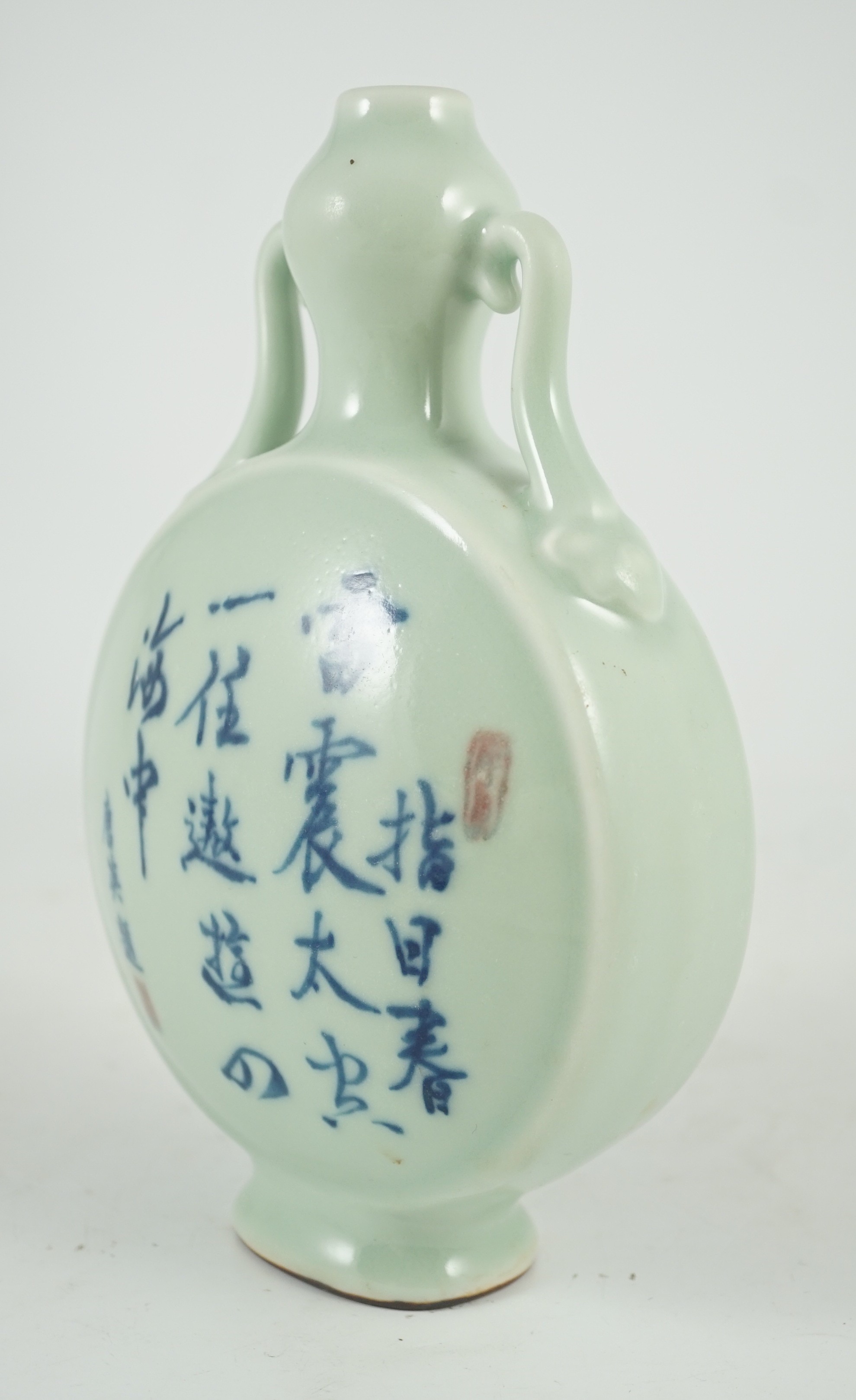 A Chinese underglaze blue and copper red inscribed celadon ground moonflask, 21cm high